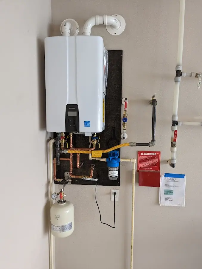 Professional plumber installing copper piping in a Morton home
